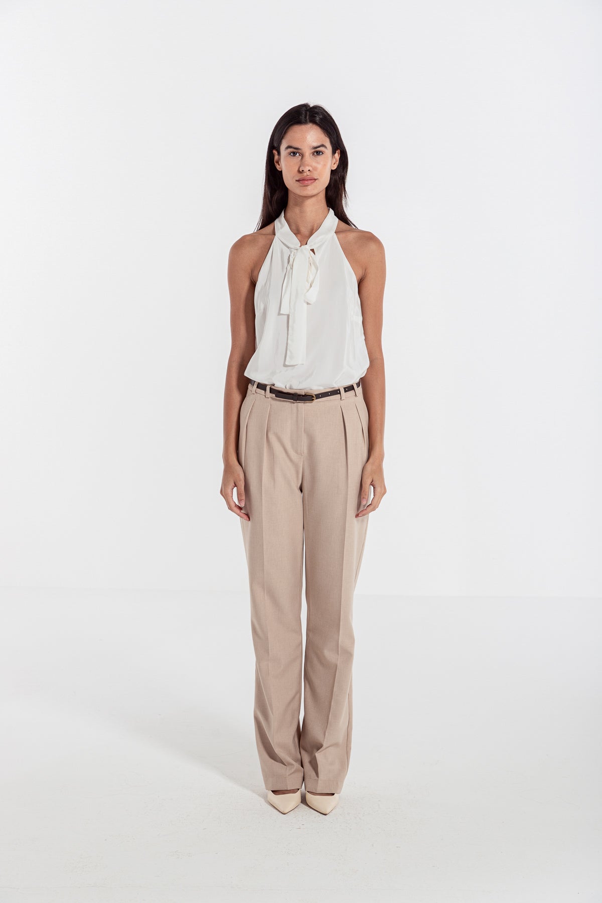 woman in beige classic front pleated pants