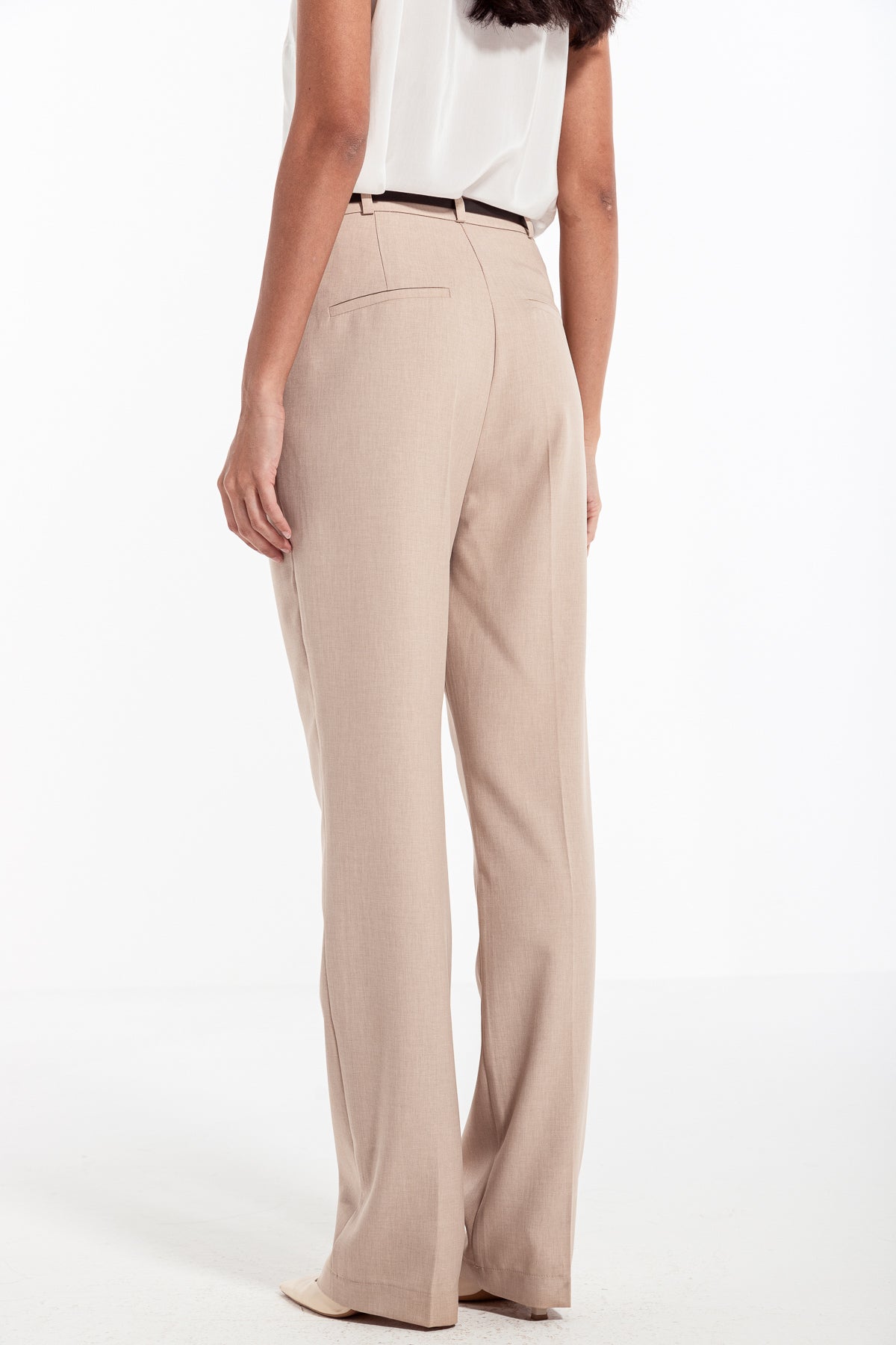 woman in beige classic front pleated pants
