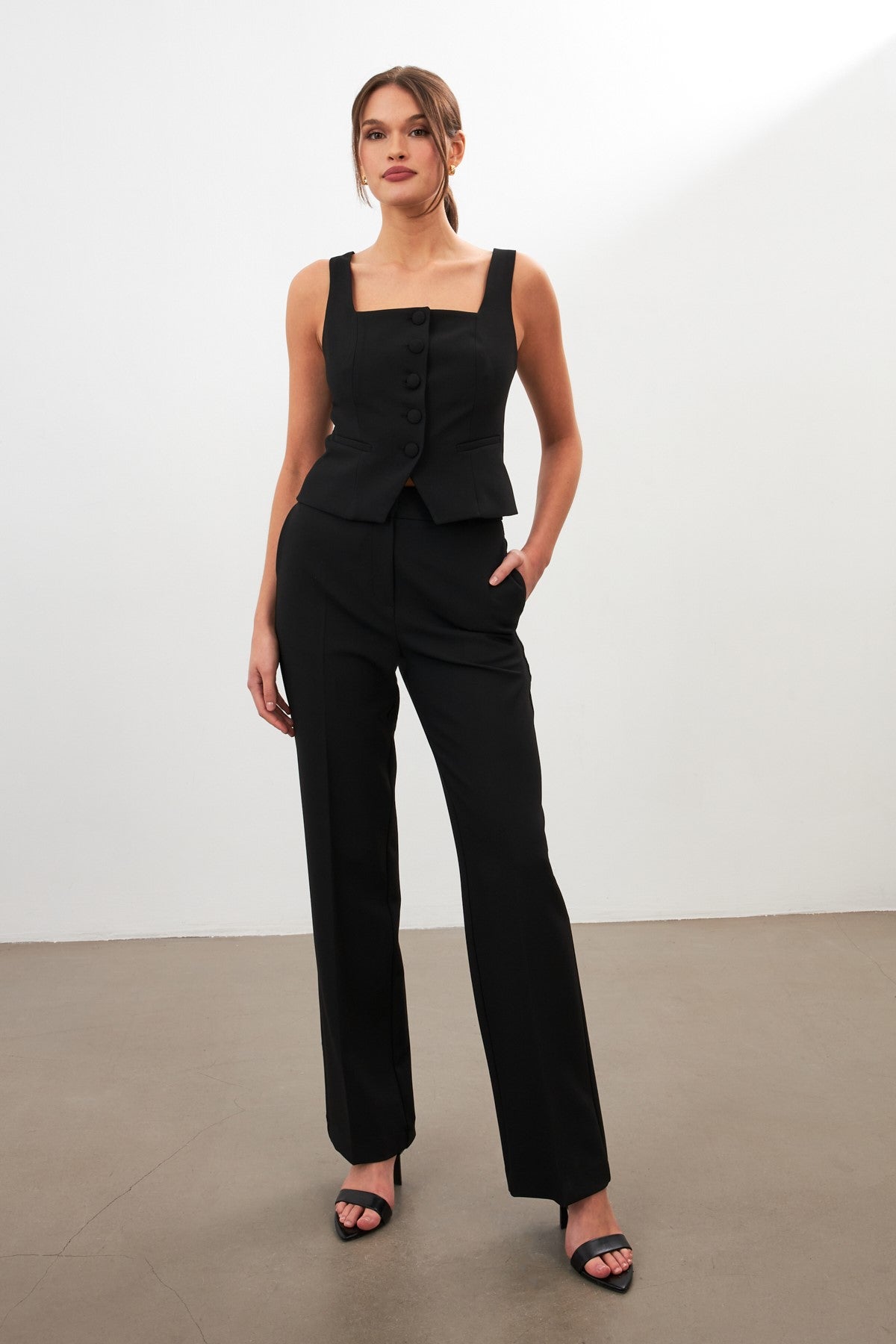 woman in black tailored suit risska