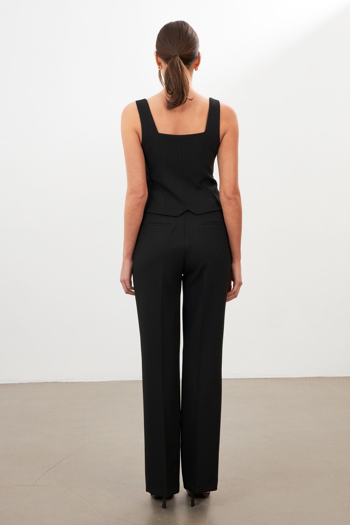 woman in black tailored suit risska