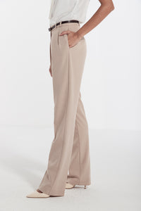 woman in beige classic front pleated pants 