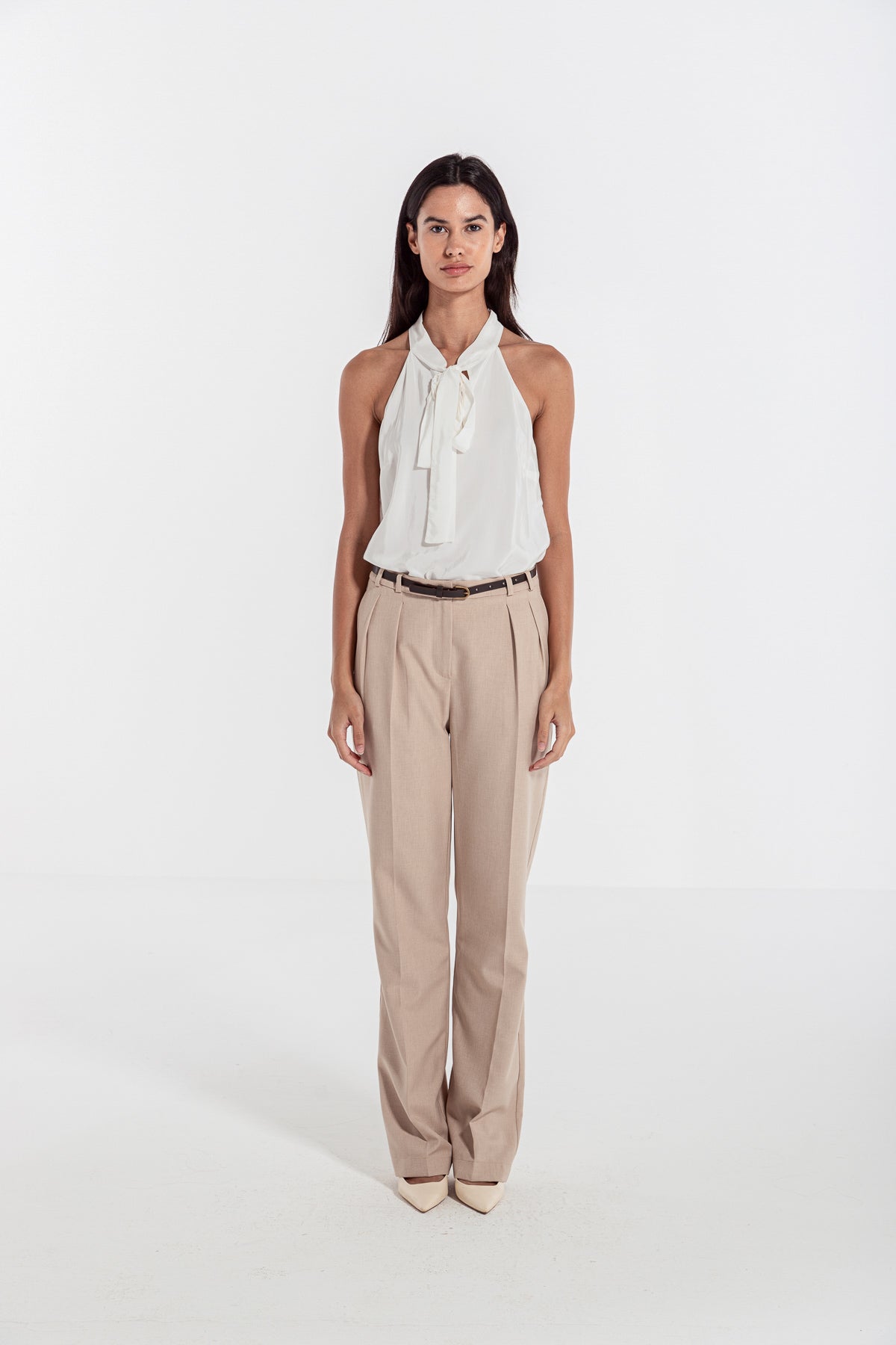 woman in beige classic front pleated pants 