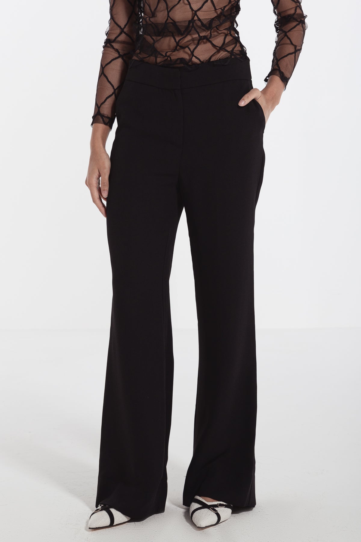 women in black straight leg crepe pants risska