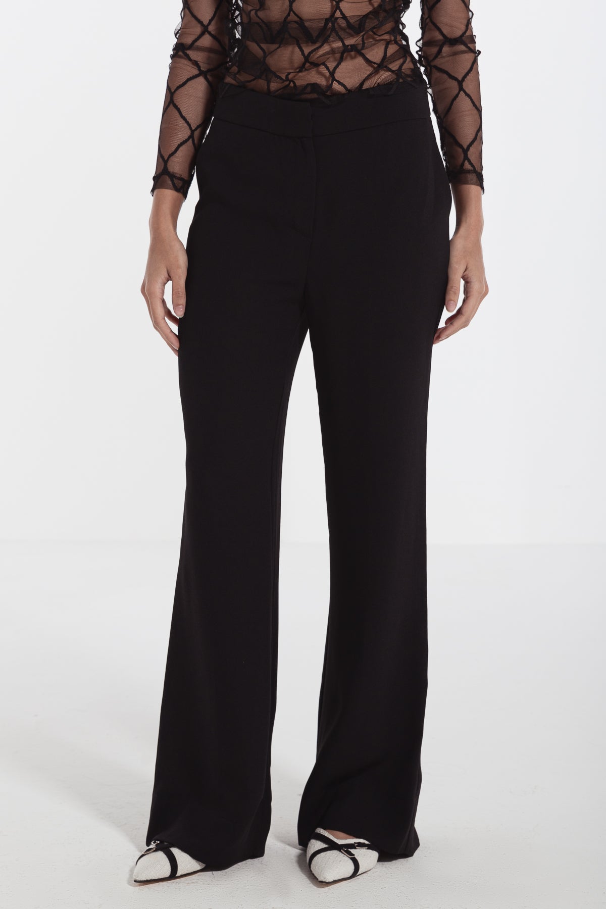 women in black straight leg crepe pants risska