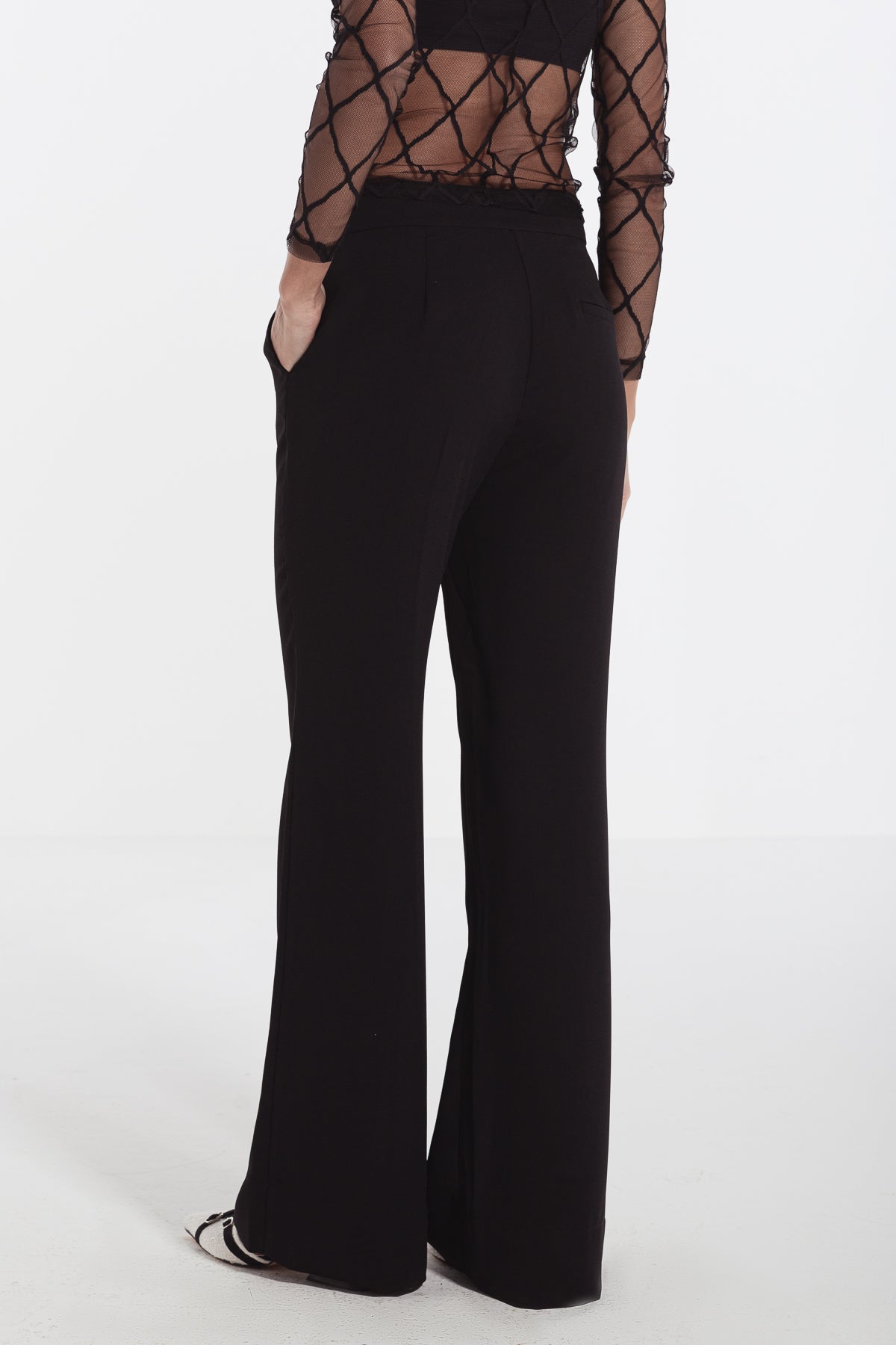 women in black straight leg crepe pants risska