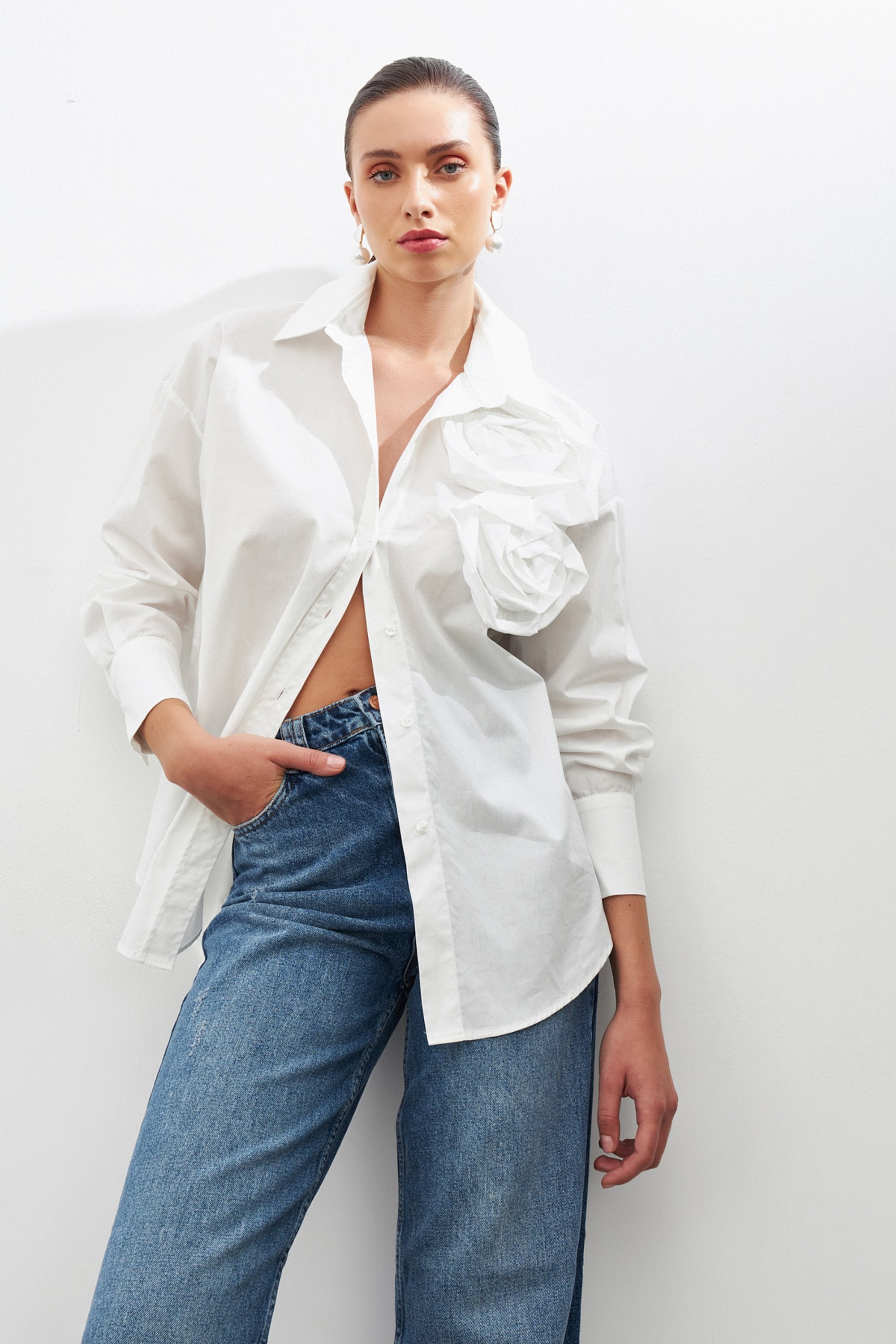 woman in loose fit white shirt with flower details