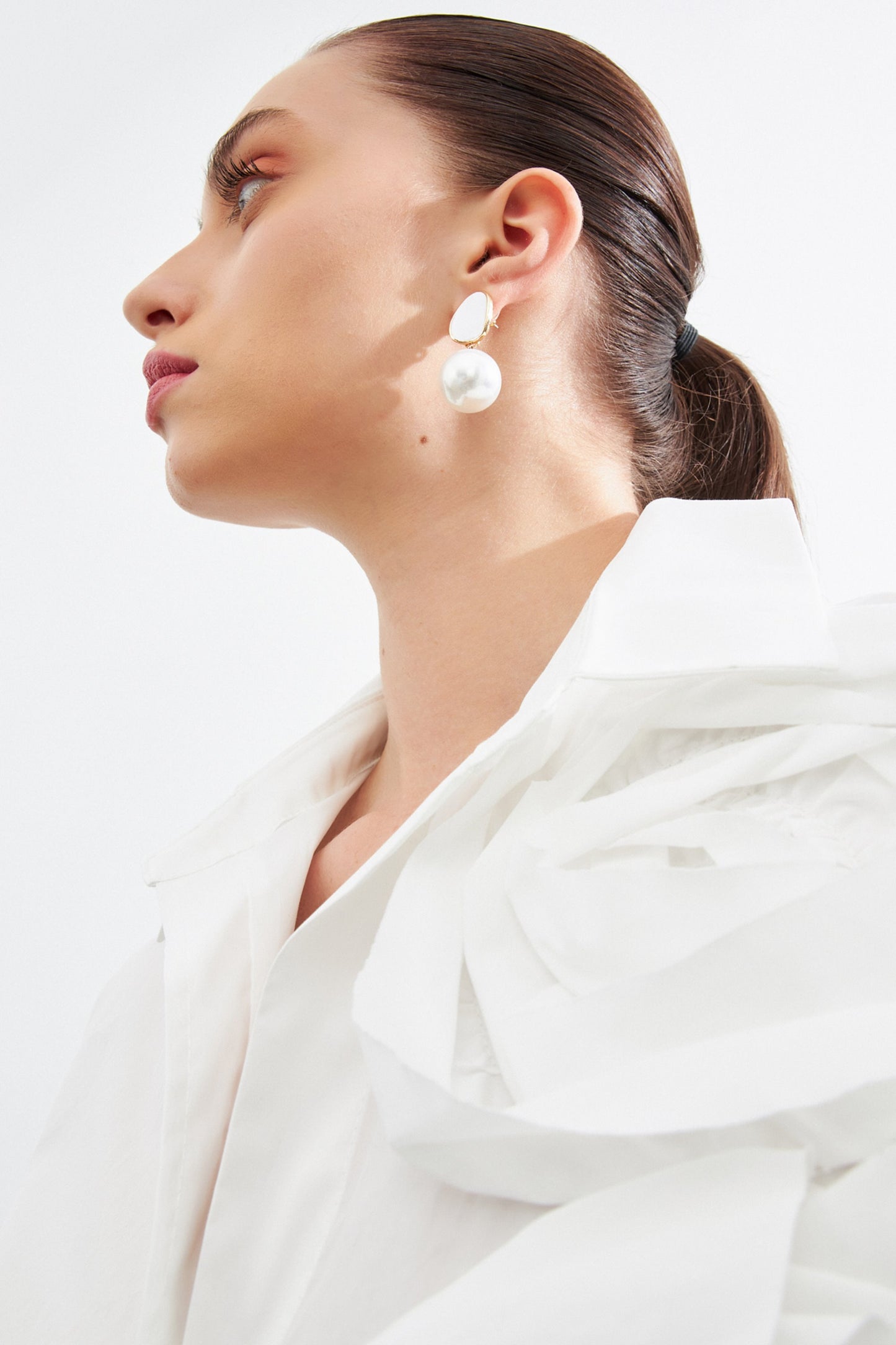 woman in loose fit white shirt with flower details